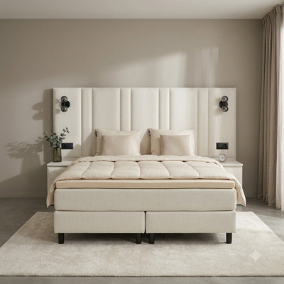 Premium boxspring met het dekbed teruggeslagen, de meegeleverde topper zichtbaar
